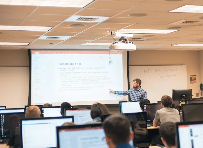 Classroom showing teacher teaching on a powerpoint slide